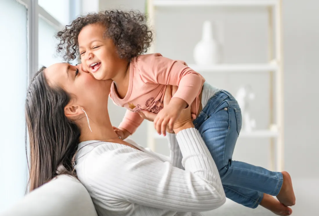 Mother cuddling child